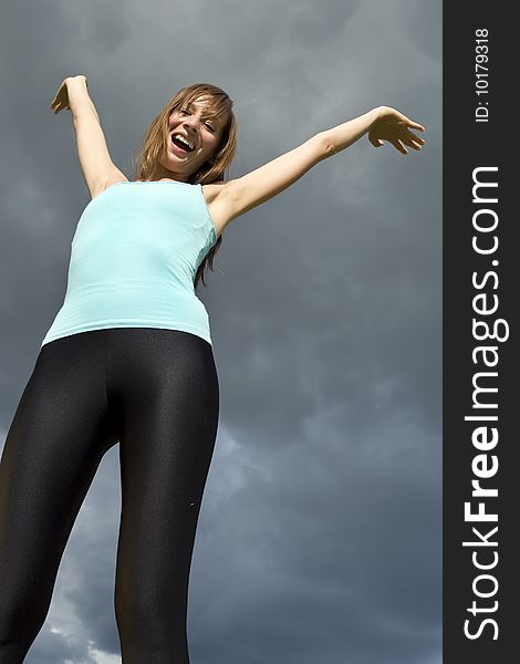 Happy woman on the dark blue skies as a background