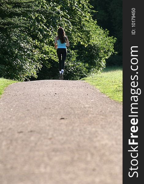 Active woman running in park by the sun. Active woman running in park by the sun