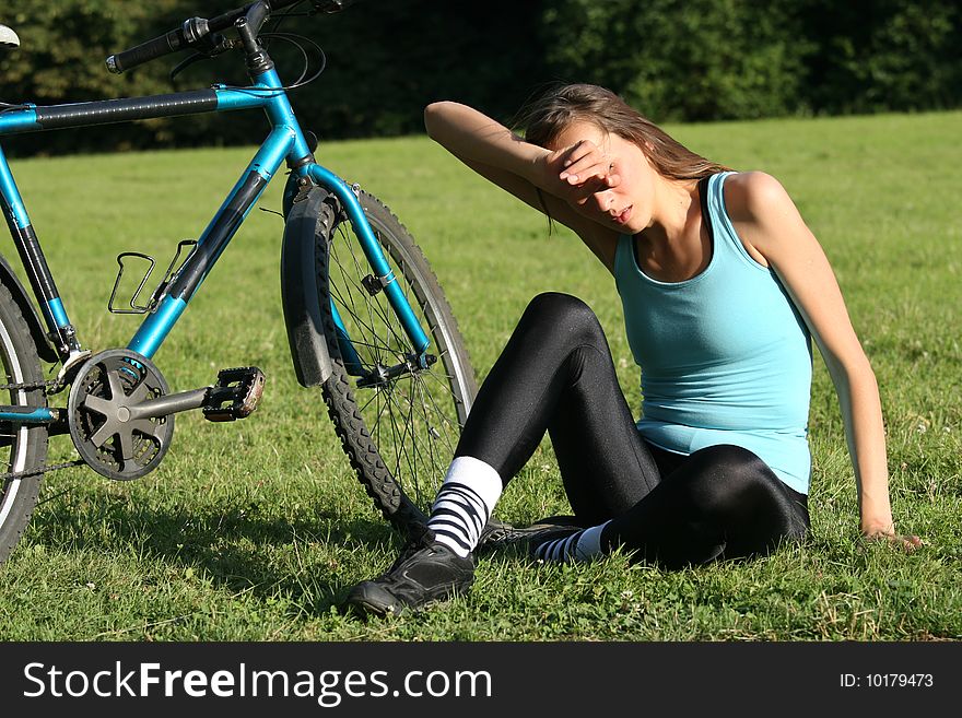 Woman relaxing on grass after sport exercises. Woman relaxing on grass after sport exercises