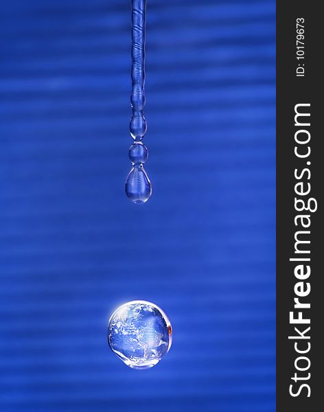 Shining water drop reflecting our planet. Shining water drop reflecting our planet