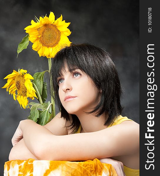 Portrait of a beautiful girl with sunflowers