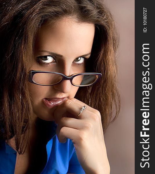 Young beautiful teacher wearing glasses. Studio shot