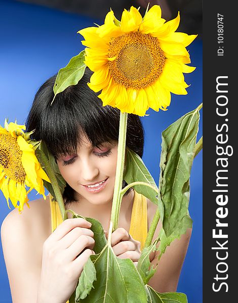 Portrait of a beautiful girl with sunflowers