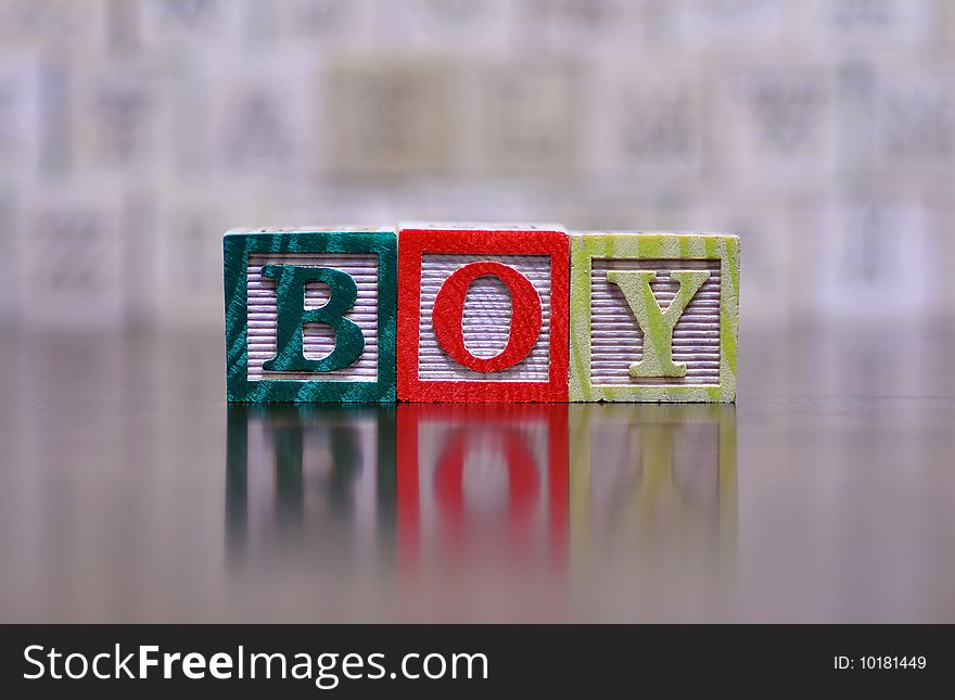 The word boy spelled out in wooden letter blocks. The word boy spelled out in wooden letter blocks