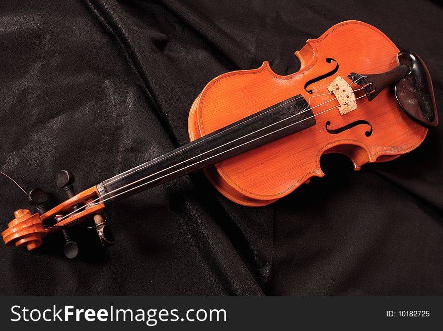 Old violin on the black background