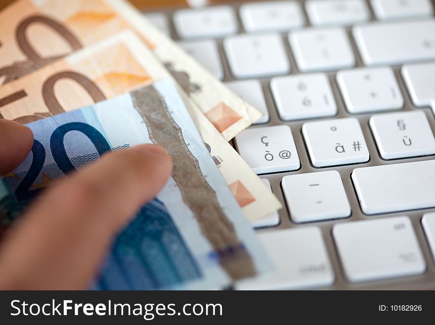 White keyboard with a euros money. White keyboard with a euros money