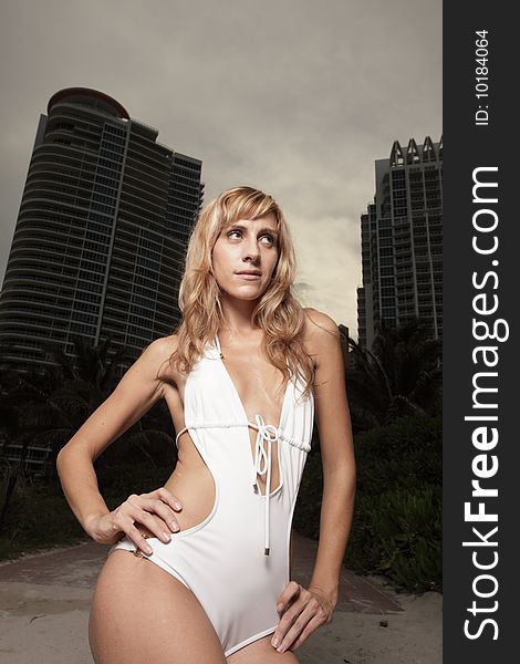 Woman posing in swimwear with buildings in the background. Woman posing in swimwear with buildings in the background