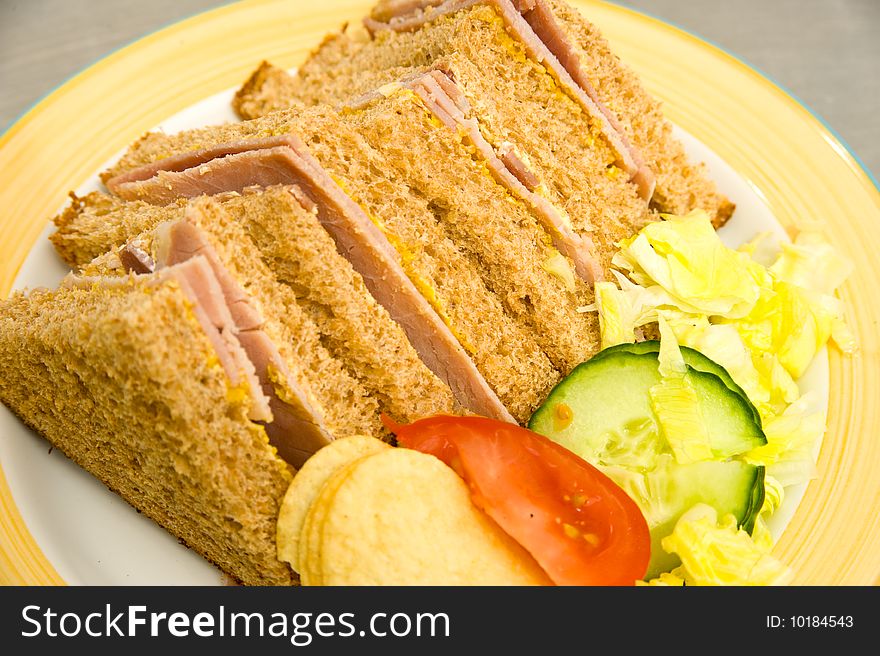 Fresh ham  with English mustard, lettuce and wholemeal brown bread served with  tomato, cucumber and potato crisps. Fresh ham  with English mustard, lettuce and wholemeal brown bread served with  tomato, cucumber and potato crisps.