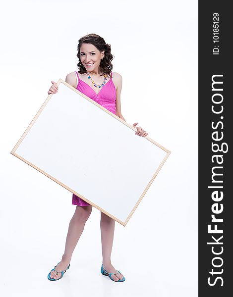 Young attractive woman on isolated background holding a blank board and smiling. Young attractive woman on isolated background holding a blank board and smiling