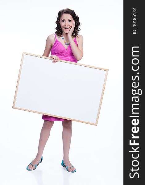 Young attractive woman on isolated background holding a white board. Young attractive woman on isolated background holding a white board