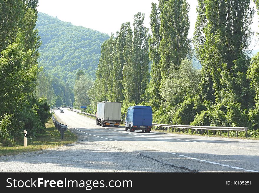Trucks drive along the mountain serpentine road
