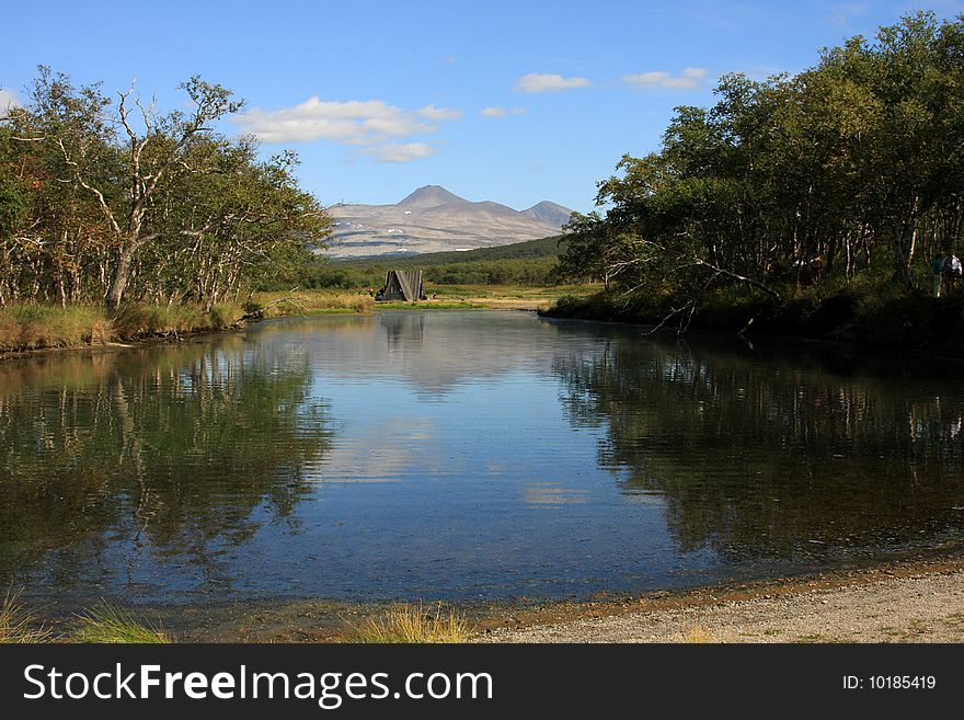 There are hot springs close to Khodutkinskiy volcano, Kamchatka, Russia. Water at far bank is too hot to place even a hand into it.