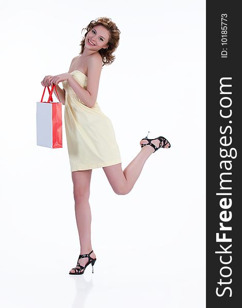 Young woman with shopping bag laughung and running. Young woman with shopping bag laughung and running