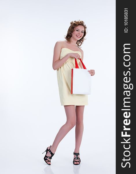 Young woman with shopping bag smiling. Young woman with shopping bag smiling