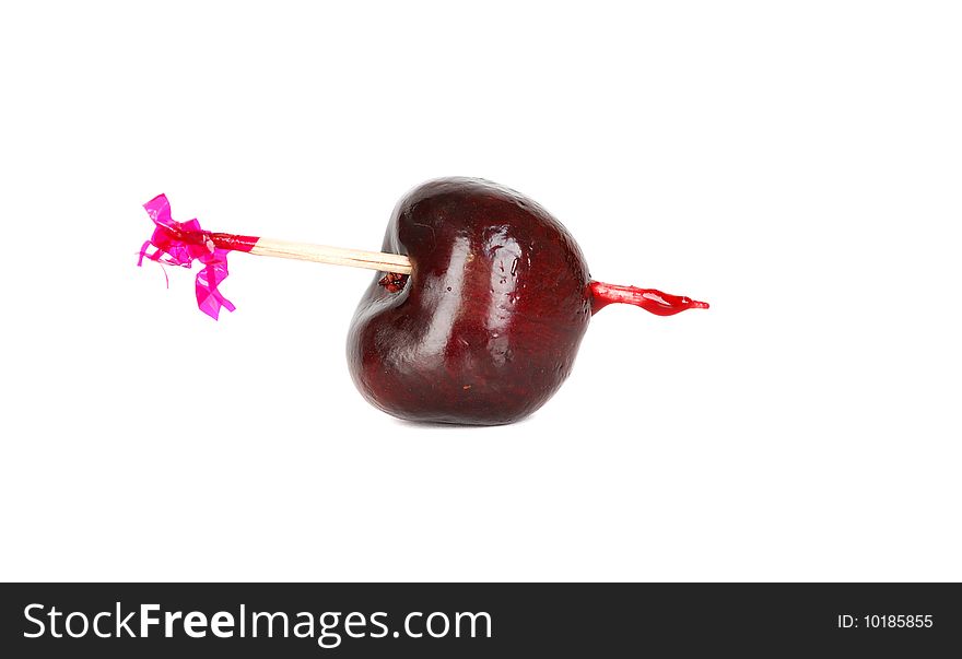 Black fresh ripe one cherry on the wood pick isolated on the hate background. Black fresh ripe one cherry on the wood pick isolated on the hate background.