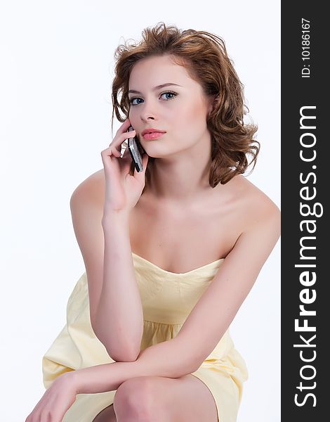 Young attractive sad woman on isolated background speaking over the mobile phone. Young attractive sad woman on isolated background speaking over the mobile phone