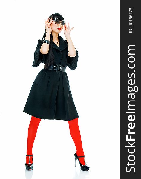 Charming model in black light overcoat, sun glasses and red tights