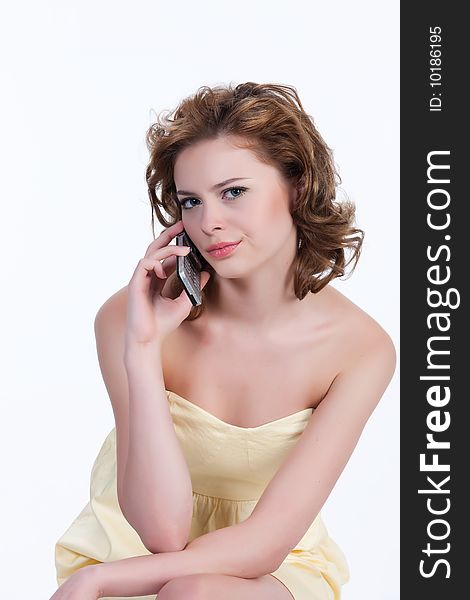 Young attractive emotional woman on isolated background speaking over the mobile phone. Young attractive emotional woman on isolated background speaking over the mobile phone