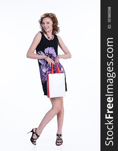 Young woman with shopping bag smiling. Young woman with shopping bag smiling