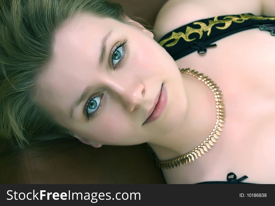 Beauty woman with green eyes and gold necklace
