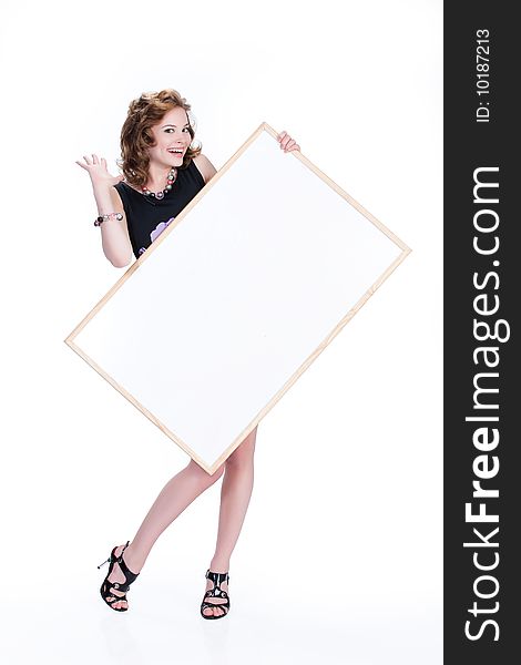 Young emotional woman on isolated background holding a blank board