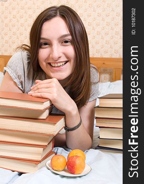 Young smiling student woman with books