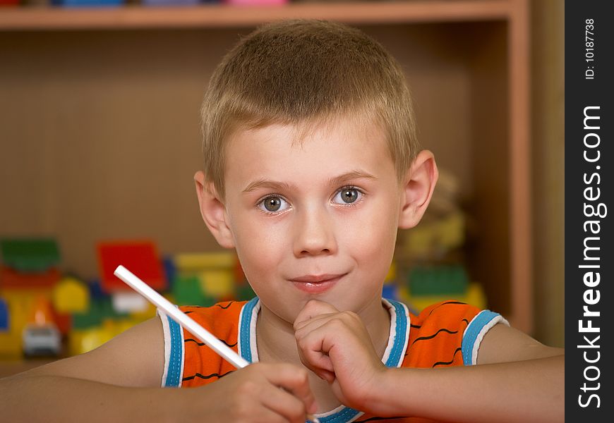 The boy of 7 years is engaged in a children's room