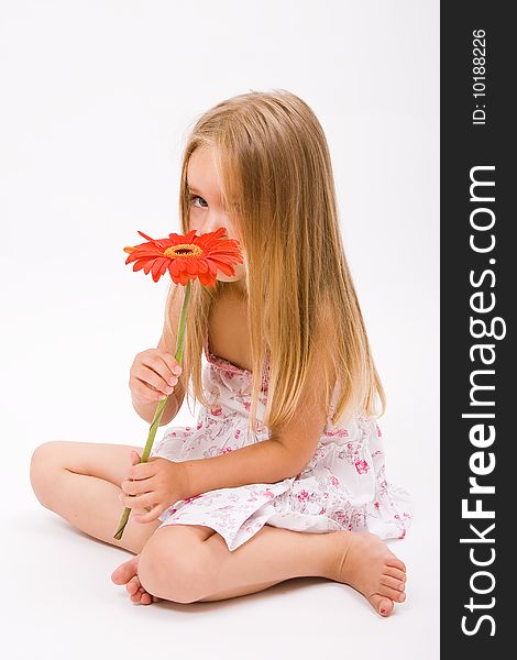 Beautiful little girl with long blonde hairand red flower