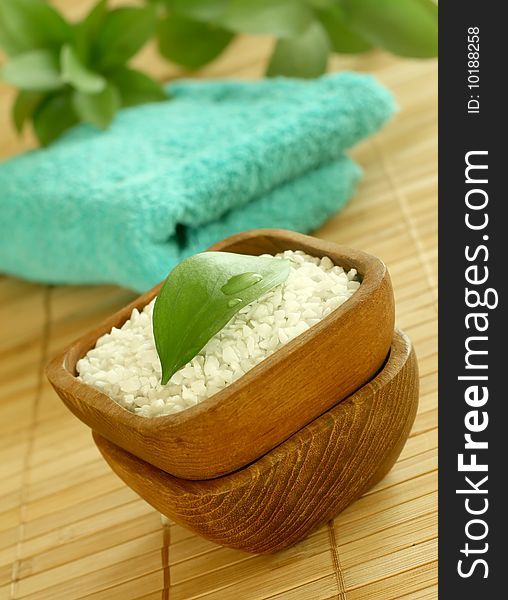 Bath salt in wooden bowl and towel. Spa concept.