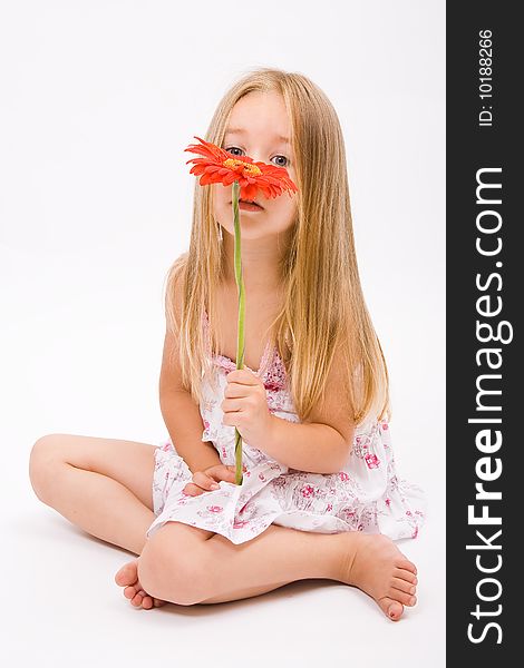 Beautiful little girl with long blonde hairand red flower