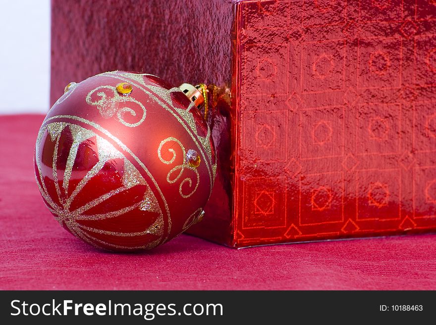 Red decorated bauble and and red gift box. Red decorated bauble and and red gift box