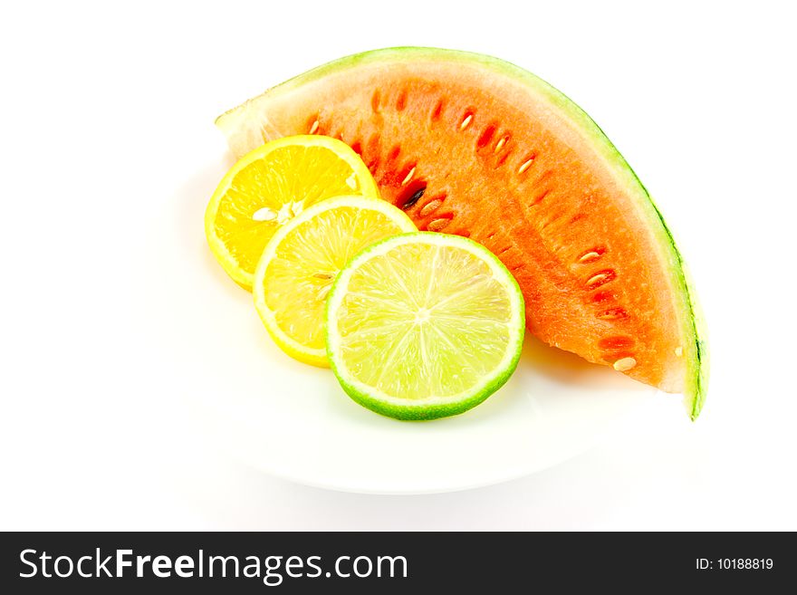 Slices of lemon, lime and orange with a slice of juicy watermelon on a white background. Slices of lemon, lime and orange with a slice of juicy watermelon on a white background