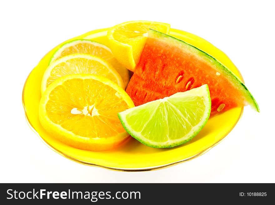 Lemon, lime and orange segments on a fancy yellow plate with juicy watermelon on a white background. Lemon, lime and orange segments on a fancy yellow plate with juicy watermelon on a white background