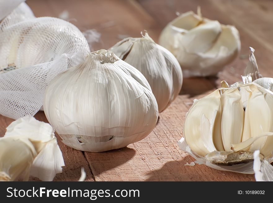 Fresh garlic cloves on wooden table