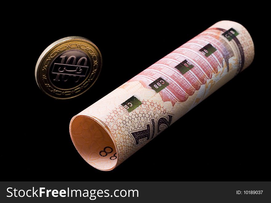 Kingdom of Bahrain currency banknote roll and coin isolated on black background. Kingdom of Bahrain currency banknote roll and coin isolated on black background