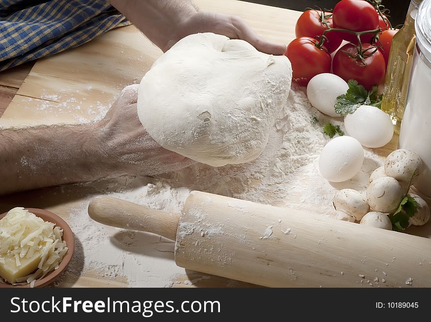 Shot of person kneading dough for pizza. Shot of person kneading dough for pizza