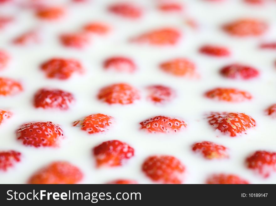 Strawberry in milk, close up