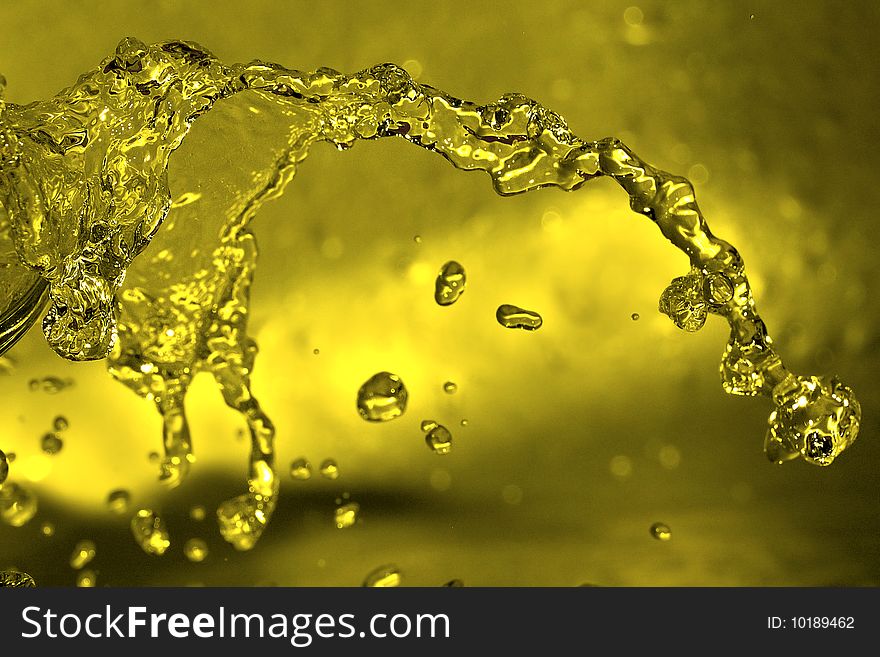 Shot of water splashing and yellow drop