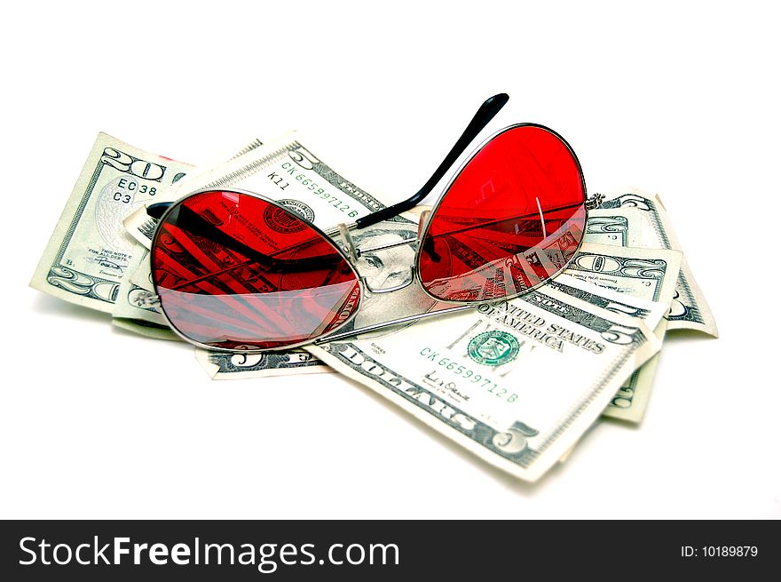 Red Sunglasses Resting On Cash