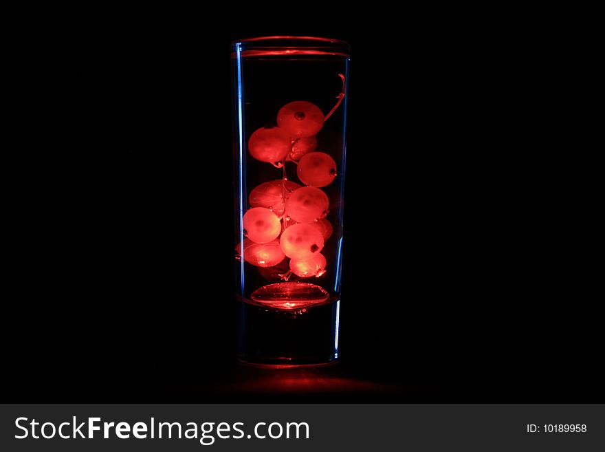 Red current in the glass of water. Red current in the glass of water