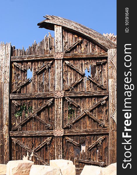 Wooden door isolated against the blue sky. Wooden door isolated against the blue sky.