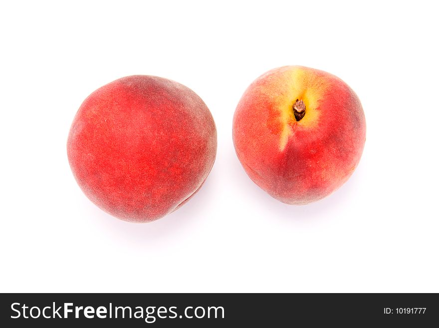 Two fresh peaches on white background
