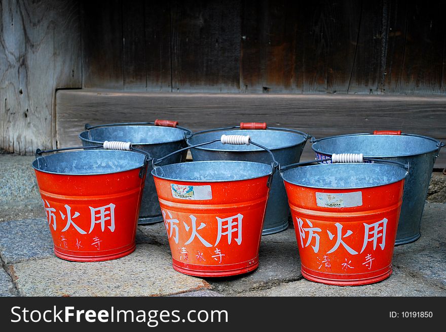 Red buckets near japanese temple. Red buckets near japanese temple