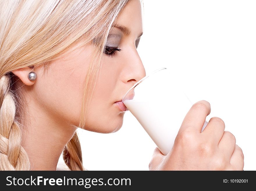 Beautiful woman drinking milk on a white background