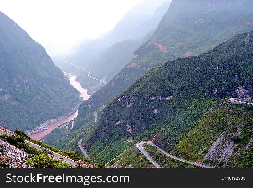 Mountain road through valley, Tibet, China