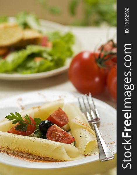 Appetizer with cheese, tomatoes and black olives. Appetizer with cheese, tomatoes and black olives