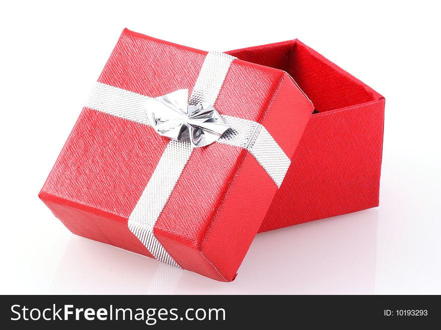 Red gift box with silver ribbon isolated on white. Red gift box with silver ribbon isolated on white.