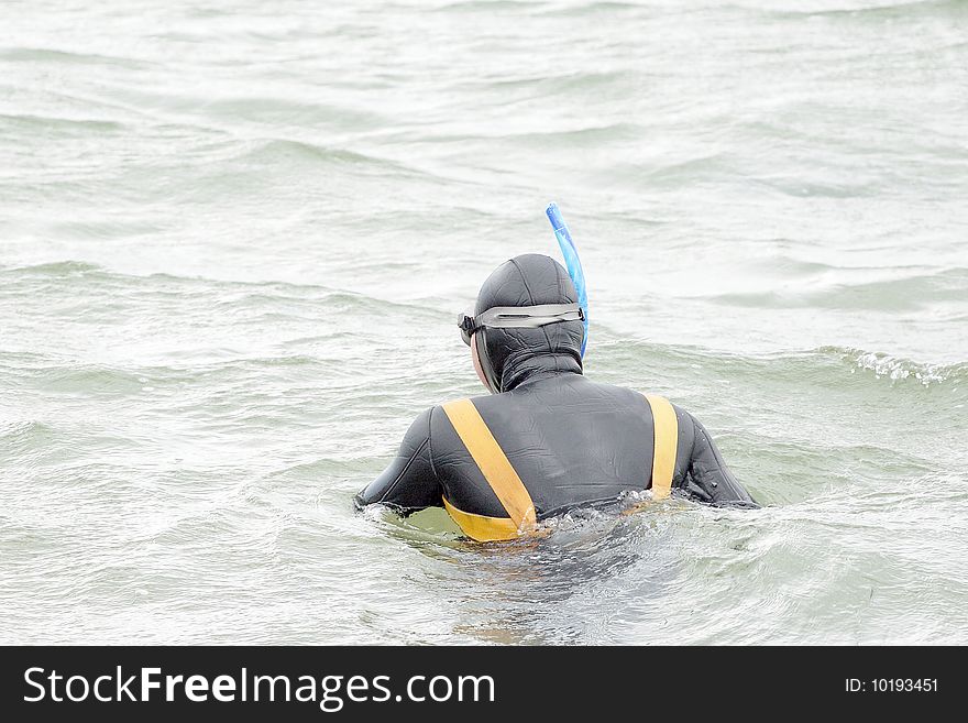 Diver stands among the sea water