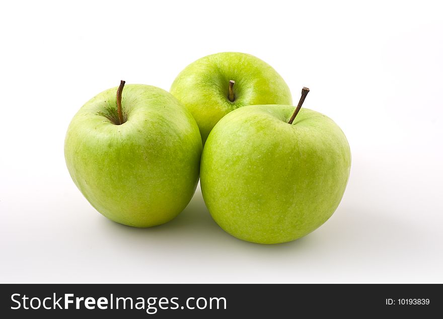 Three green apples on white