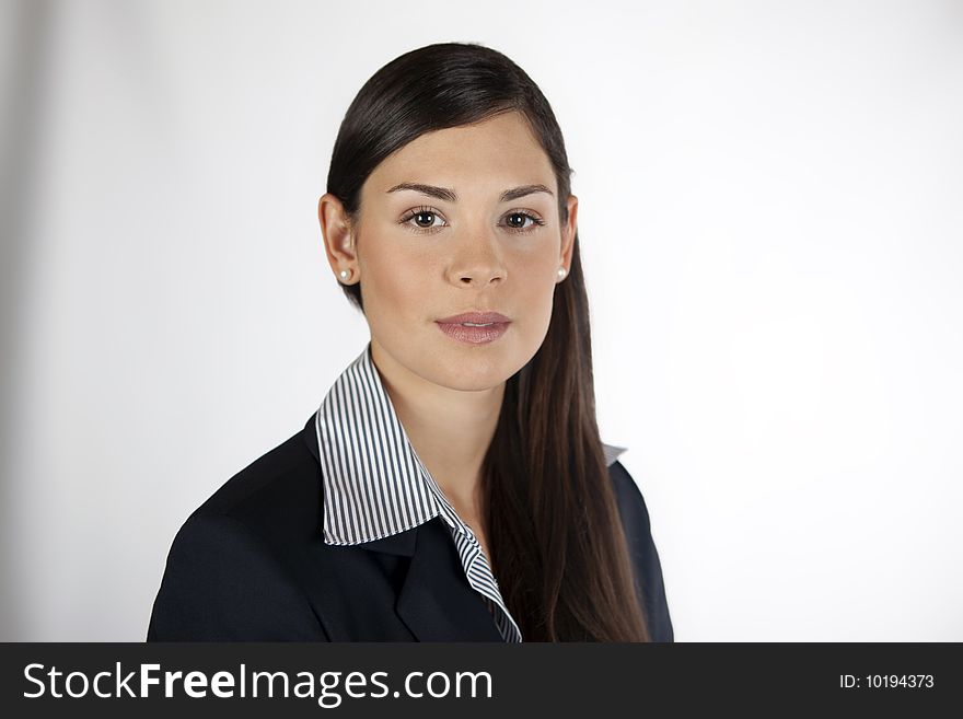 Young confident business woman facing the camera. Young confident business woman facing the camera